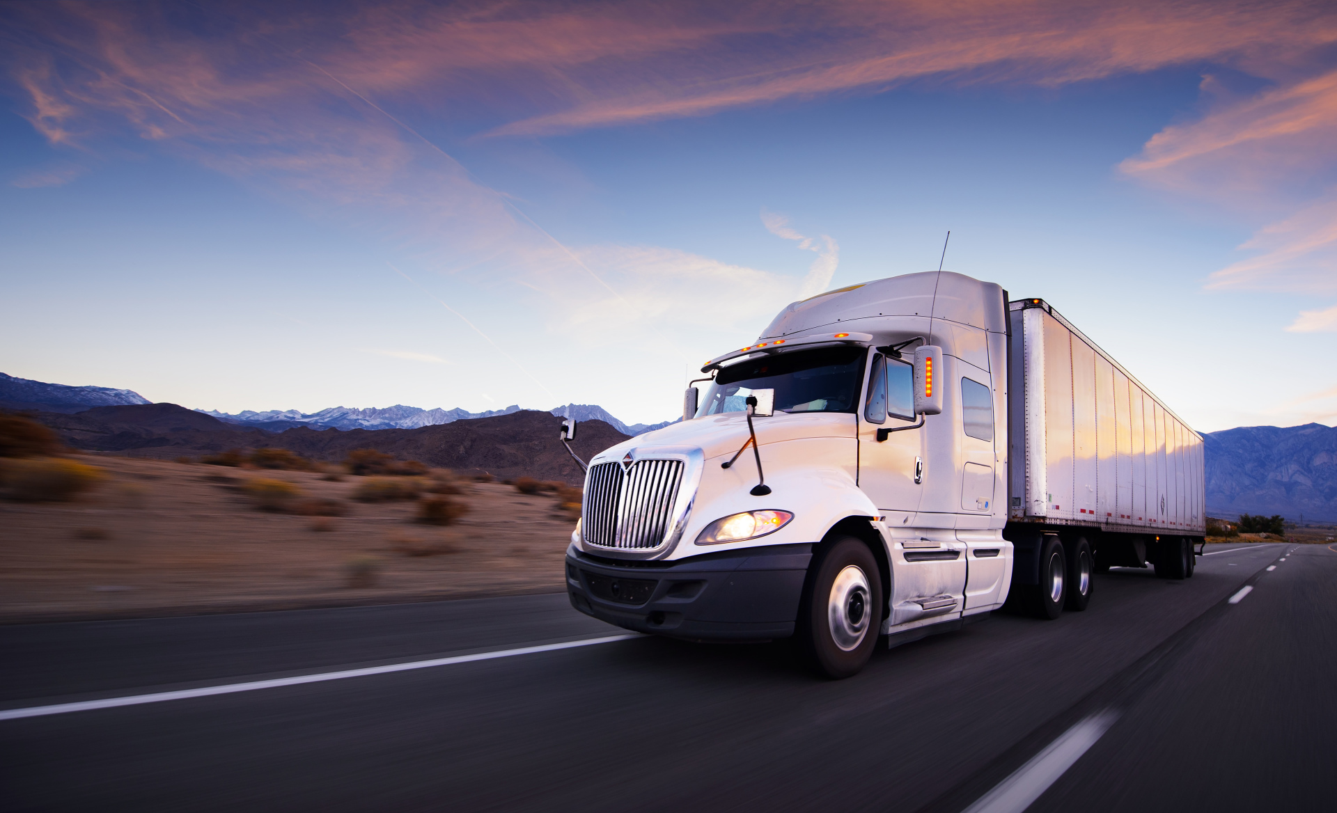 Truck and highway at sunset - transportation background Truck and highway at sunset - transportation background